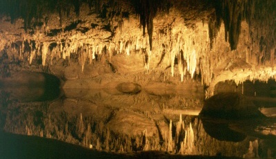 Trek Cliff Cavern showing stalictites reflected in a pool of water